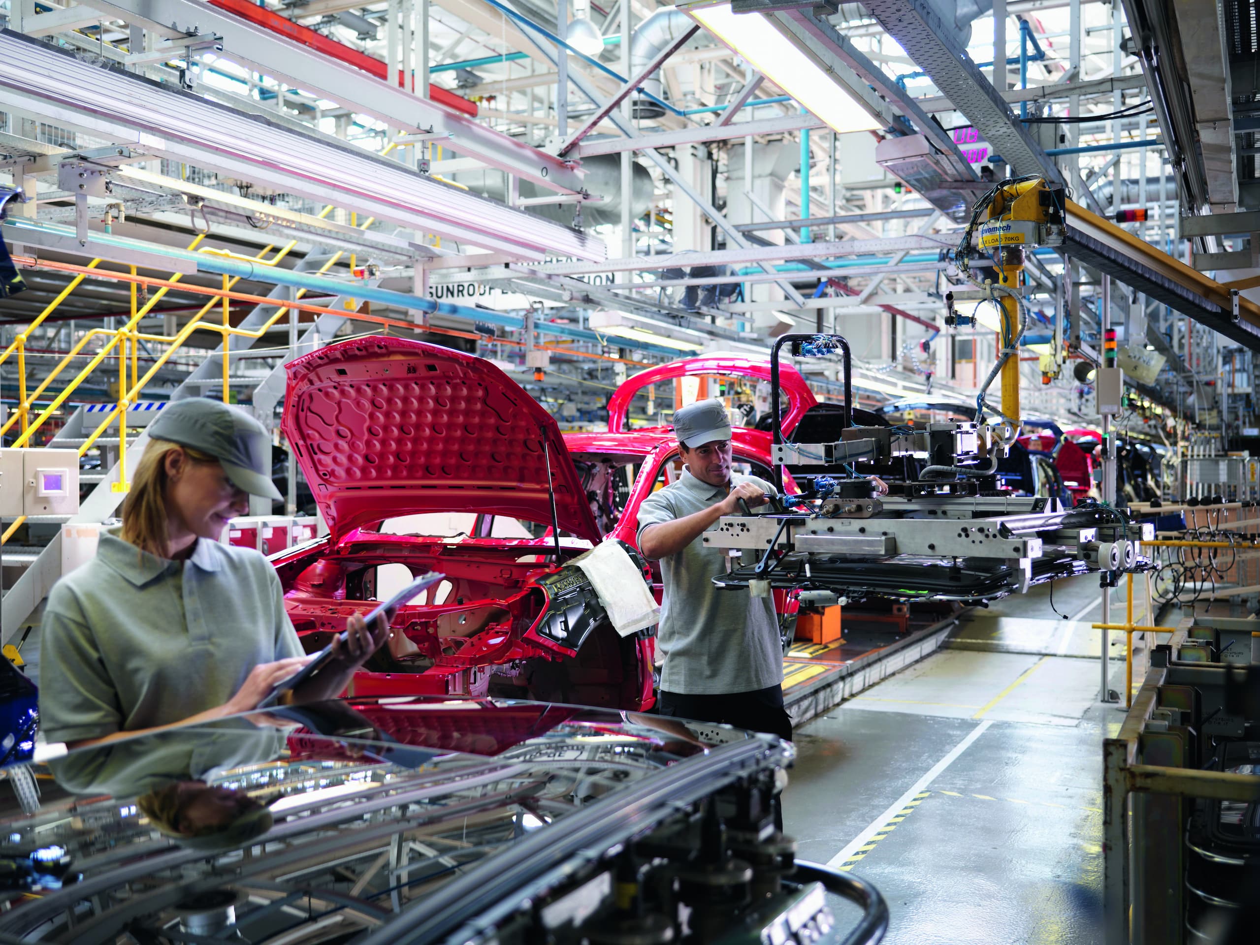 Car Plant Workers On Production Line