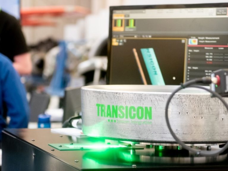 A Transicon logo is seen on a piece of equipment at a manufacturing expo.